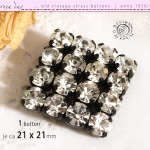 May include: A vintage strass button with clear crystals set in a black frame. The button is square and measures approximately 21 x 21 mm. The image includes text that reads "rosa day" and "design by KARIN".