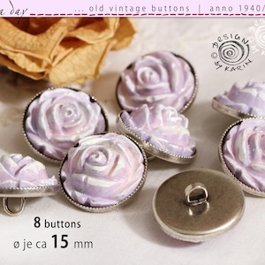 May include: Eight vintage buttons with a rose design. The buttons are light purple and white with a silver-colored metal rim. The text on the image says "rosa day" and "old vintage buttons | anno 1940/50/60". Each button is approximately 0.6 inches in diameter.