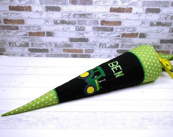 May include: A black and green school cone with a green tractor design and the name "BEN" embroidered on the side. The cone is decorated with white stars on a green background.