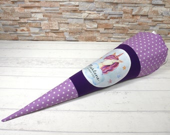 May include: Purple and white school cone with a unicorn and the name Marlene on a cloud. The cone is decorated with white stars.
