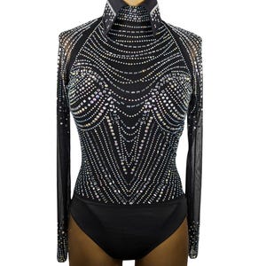 May include: A black long-sleeved bodysuit with a high mock neck and a geometric pattern of iridescent rhinestones.
