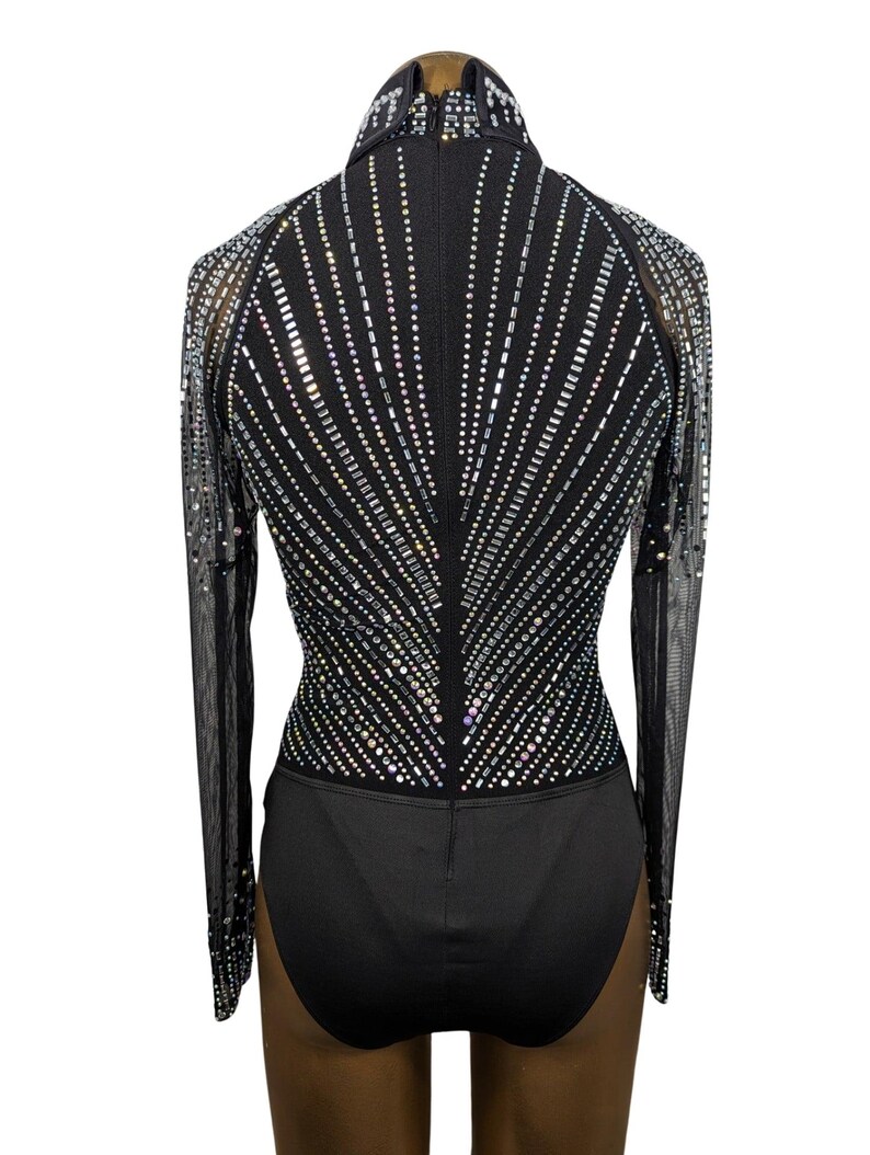 May include: Black long-sleeved bodysuit with a high neckline and a geometric pattern of iridescent rhinestones on the front and back.