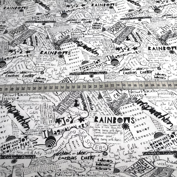 Fabric with the lettering "Word Collage-White" from the Writing On The Wall series by Free Spirit, white with black, made of cotton