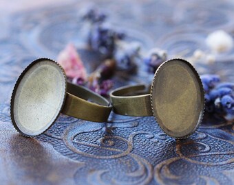 May include: Two brass rings with oval-shaped bezels, perfect for adding a personal touch to jewelry projects.