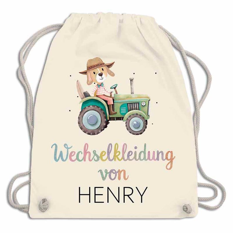 May include: A cream-colored drawstring backpack featuring a whimsical illustration of a dog driving a green tractor. The text "Wechselkleidung von HENRY" is written in colorful script below the illustration.