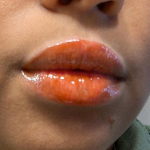 Spiced lip gloss deep orange brown color