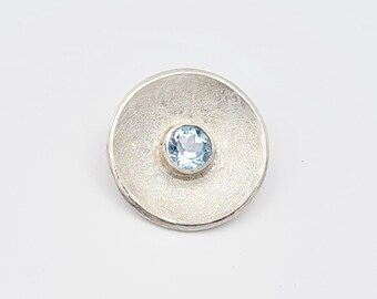 Unique "concave" pendant with blue topaz