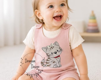 May include: A baby wearing a pink romper with a kitten graphic and a white shirt underneath. The romper has a cute kitten design with a red collar. The baby is smiling and looking up. The text "Dragam Design" is visible.