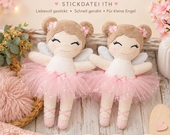 May include: Two plush dolls with light brown hair styled in buns, featuring embroidered facial features, pink blush, white tops, light blue wings, and pink tulle skirts. The dolls wear pink ballet slippers with crisscross ribbon detailing.