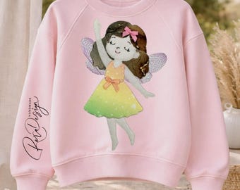 May include: Pink sweatshirt featuring a fairy design with a yellow and green dress, brown hair, and a pink bow. The fairy has wings and is waving. The sleeve has the text "Handmade Rex Design" in cursive.