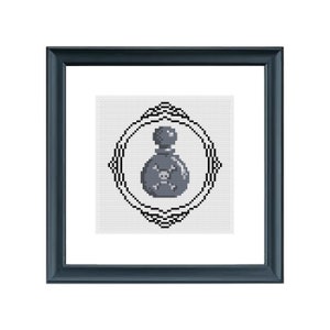 May include: A black and white cross stitch pattern of a potion bottle with a skull and crossbones design inside a decorative frame.
