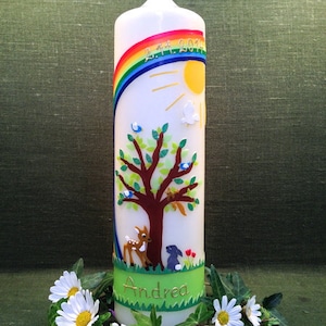 Könnte beinhalten: Weiße Taufkerze mit einem Regenbogen, Sonne, Baum, Reh, Kaninchen und grünem Gras. Die Kerze trägt das Datum "2.11.2017" und den Namen "Andrea".