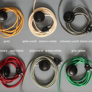 May include: Assortment of 10 colors of electrical cords with in-line switches. The cords are coiled and feature a variety of colors including yellow, gold, white, black, red, green, and blue.