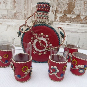 Shot bottle in leather case, shot glasses