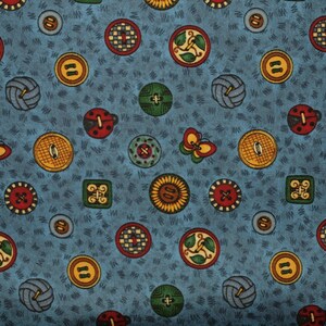 May include: A fabric pattern featuring a variety of colorful buttons and decorative elements on a blue background. The buttons are round, square, and butterfly-shaped, with intricate designs in red, yellow, green, and brown.