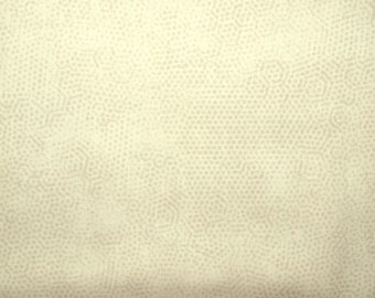 May include: A close-up of a cream-colored fabric with a subtle pattern of small, light brown dots. The fabric has a smooth, slightly textured surface.