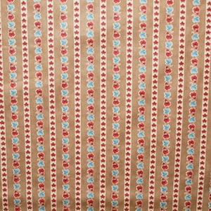 May include: A brown fabric with a repeating pattern of red and blue flowers. The fabric has a striped background.