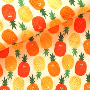 Op de afbeelding: Een naadloos stoffenpatroon met een herhalend ontwerp van gele en oranje ananas met glimlachende gezichten. De ananas hebben een textuur en zijn geplaatst op een licht perzikkleurige achtergrond.
