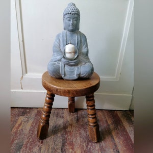 old three-legged stool turned vintage flower bench stool