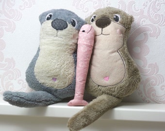 Cuddly toy baby child otter couple with fish