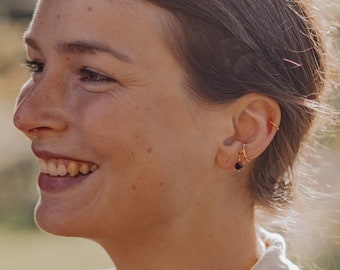 Small ear cuff with garnet pendant