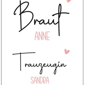Pode incluir: Um cart&atilde;o branco com texto preto que diz "Braut Anne" e "Trauzeugin Sandra" com dois cora&ccedil;&otilde;es cor-de-rosa. O texto "Fridays Feier" est&aacute; na parte inferior do cart&atilde;o.
