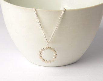 Necklace pendant circle made of silver dots