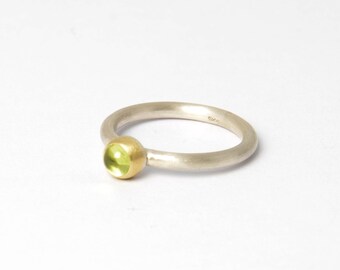 Silver ring with light green peridot in real gold setting