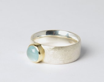 Wide silver ring with light blue aquamarine in 585 gold setting