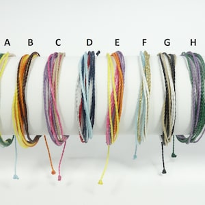 May include: Eight colorful braided bracelets with different colors and textures, labeled A through H.