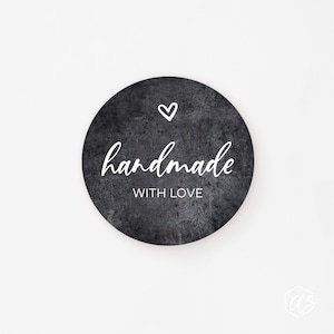 May include: Black and white round sticker with a distressed texture. The sticker says "handmade with love" and has a small heart in the top left corner.