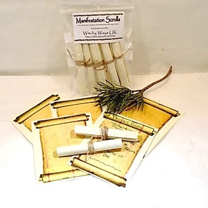 May include: A set of five white rolled parchment scrolls with twine tied around them. The scrolls are labelled "Manifestation Scrolls" and "Witchy Ways UK". The scrolls are on a white surface with a pine branch and other scrolls.