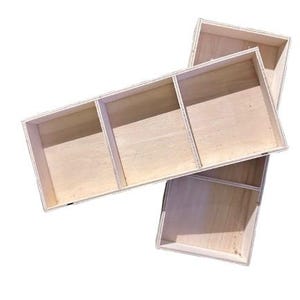 May include: Two unfinished wooden storage boxes. One box is divided into three compartments, and the other is divided into two compartments. The boxes are made of light-colored wood and have a simple, rectangular design. They are suitable for organizing small items.