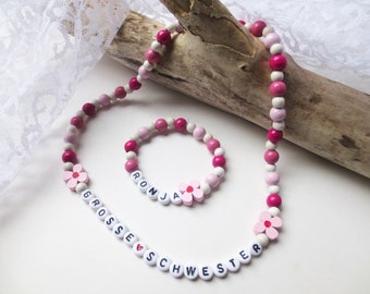 Parure de bijoux pour GRANDE SOEUR, perles en bois, fleurs, colorées, rose, blanc, rose, prénom souhaité, élastique, bracelet, collier, personnalisable