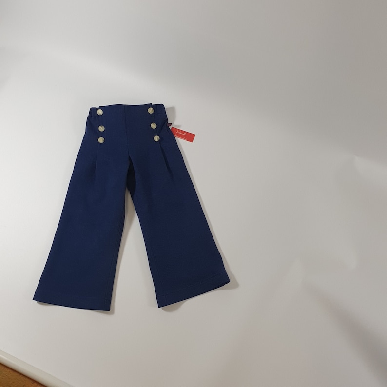 Children's jeans pants, sailor jeans made of dark blue cotton denim for boys and girls. image 1