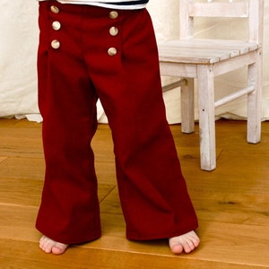 Puede incluir: Pantalones de marinero rojos con botones dorados. Los pantalones tienen una pierna ancha y est&aacute;n hechos de una tela suave y c&oacute;moda.