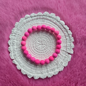 Könnte beinhalten: Eine weiße Keramik-Tasse mit schwarzem Henkel und dem Text "But First, Coffee" in fetter, schwarzer Schrift. Die Tasse steht vor einem neutralen Hintergrund, der ihr schlichtes Design hervorhebt.