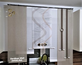 May include: Three beige window curtains with a black curtain rod. The center curtain has a white and brown abstract design. The text "Gardinien Welt ANGELINA" is visible on the left curtain.