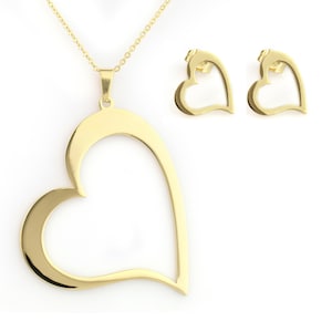 May include: A gold-colored jewelry set featuring a heart-shaped pendant necklace and matching heart-shaped stud earrings. The pendant hangs from a delicate chain. The earrings and pendant have a polished finish.