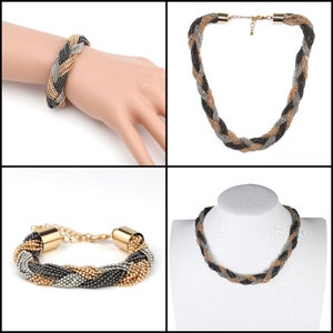 May include: A braided jewelry set featuring a bracelet and necklace. The bracelet is shown on a hand, while the necklace is displayed on a mannequin. The jewelry is made of interwoven strands of black, silver, and gold-colored beads.