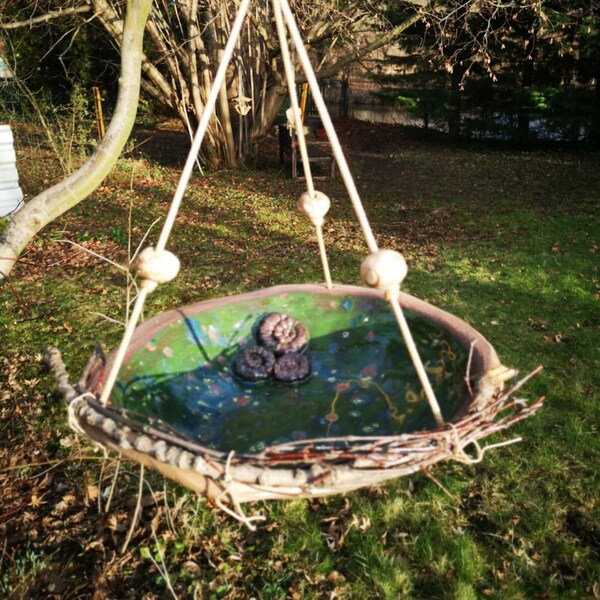 Hang or place a large bird bath in a forest meadow