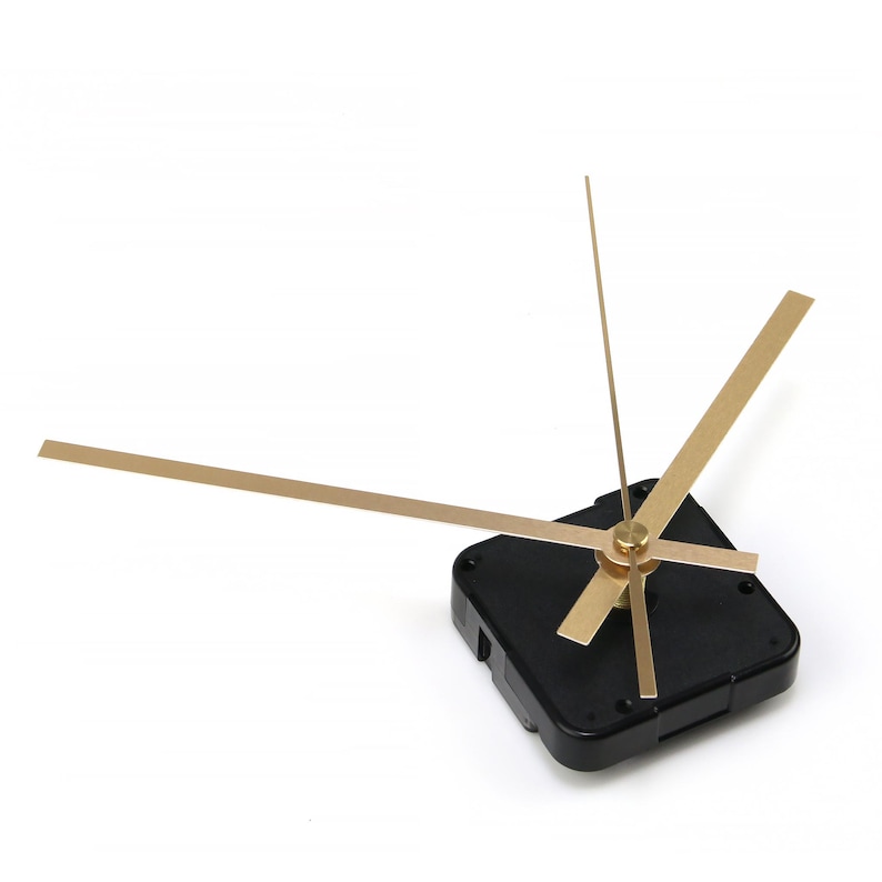 May include: Clock movement with gold-colored hands and a black square base. The hands are in different lengths, with the longest one pointing to the left. The clock mechanism is designed for DIY projects or clock repair.