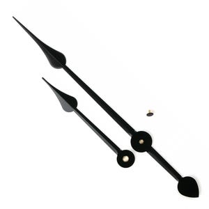 May include: Black clock hands with a teardrop-shaped end and a circular base. The set includes a long minute hand, a shorter hour hand, and a small brass-colored screw for mounting. The hands are angled against a white background.