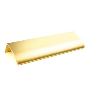 May include: A gold-colored cabinet pull with a brushed finish. The rectangular handle has a curved top and a right-angled corner on one end. This modern hardware is suitable for drawers and cabinets.