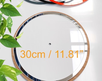 May include: A round, clear glass object with a wooden frame and a silver-colored trim. The object is 11.81 inches (30cm) in diameter. Several other circular objects in black, gray, and red are visible in the background.