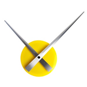 May include: A yellow clock face with silver hands that cross in the center. The hands are long and thin.
