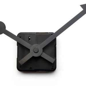 May include: Black clock hands with a square clock mechanism. The hour hand is a simple black circle, the minute hand is a black stick, and the second hand is a black arrow.