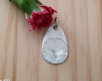 Fine silver pendant with embossed, genuine ginkgo leaf in drop shape. Unique