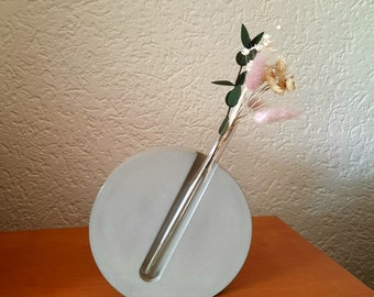 Beautiful vase for dried flowers made of concrete with a test tube