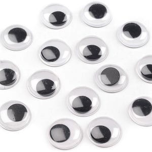 Könnte beinhalten: Eine Sammlung von 14 Glitzern in verschiedenen Größen. Die Augen sind schwarz mit einer weißen Pupille und sind auf einer durchsichtigen Plastikrückseite befestigt.